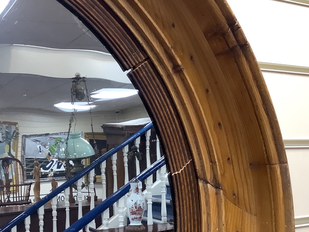 A 19th century circular pine framed mirror, diameter 68cm